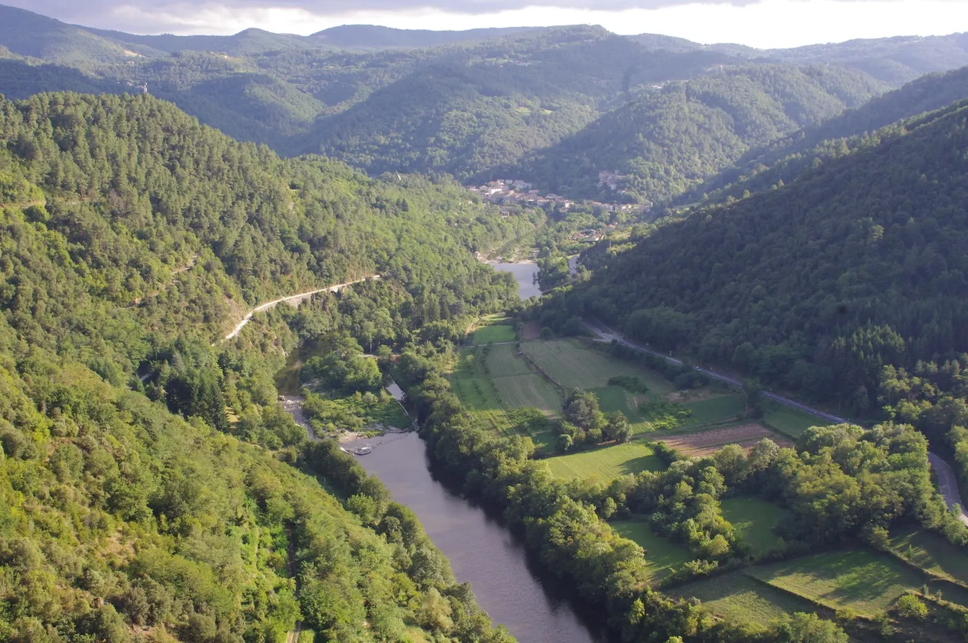 La vallée de l’Eyrieux vue depuis les hauteurs : le village, la rivière et les coteaux boisés